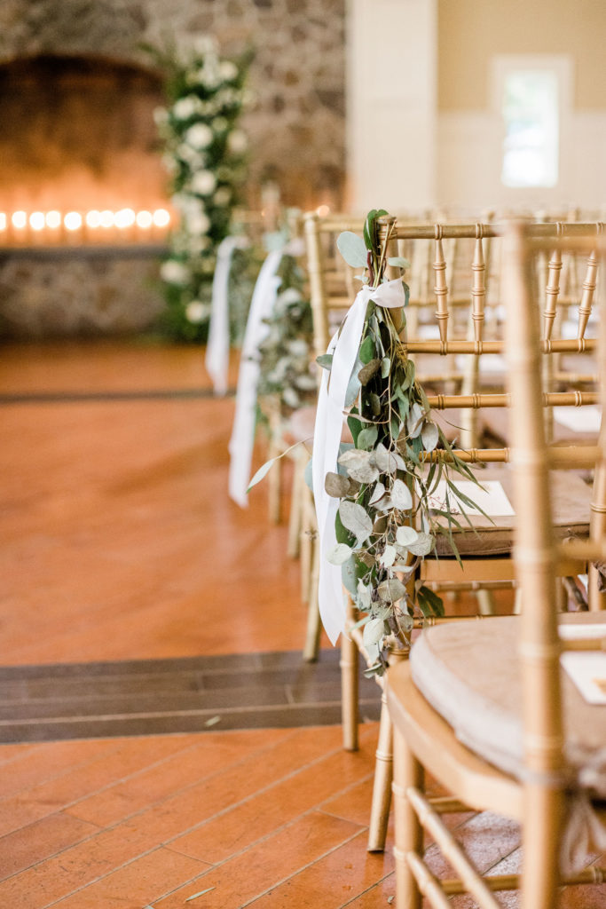 wedding ceremony chair greenery decor